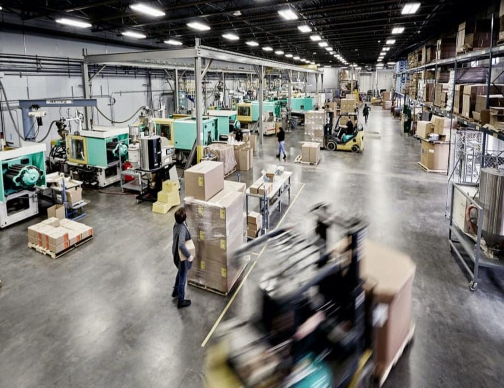 Rows of injection molding presses on the Plastic Alternatives production floor in Independence, Minnesota